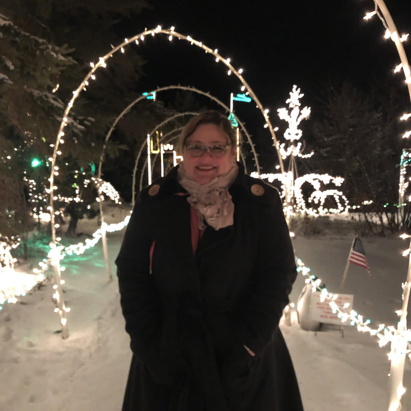 Fayemarie under a tunnel of holiday lights