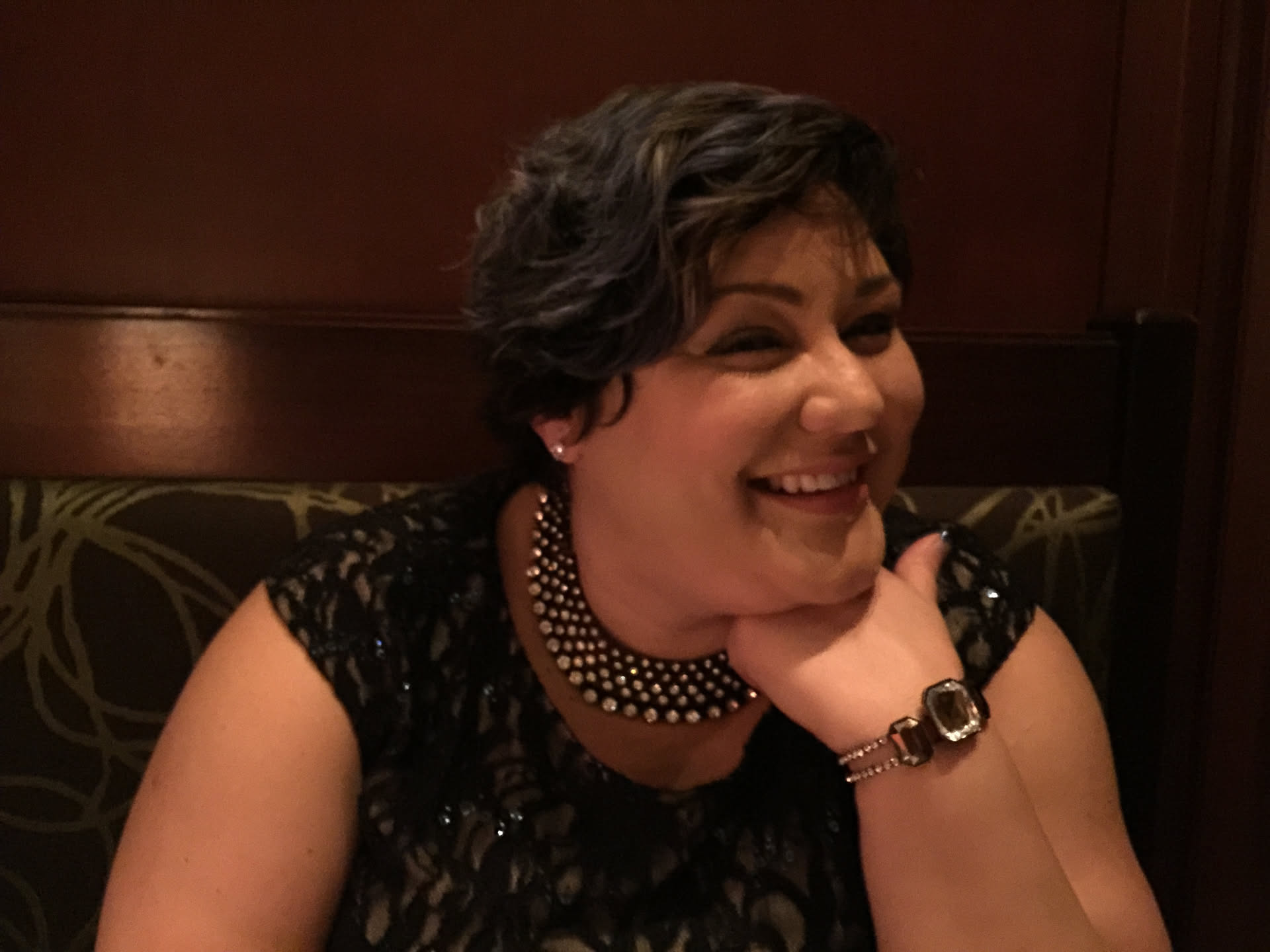 Fayemarie laughing, wearing a pearl collar necklace